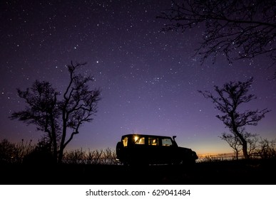 Leningrad region, Russia - April 22, 2017. Jeep Wrangler under the starry sky on the shore of the bay. Wrangler is a compact SUV produced by Chrysler