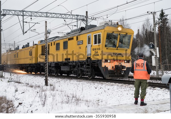 Leningrad\
region, Russia - December 18, 2015: Train maintenance railway\
carries grinding rails on the stretch of road in the winter,\
engineer-inspector checks the quality of\
work