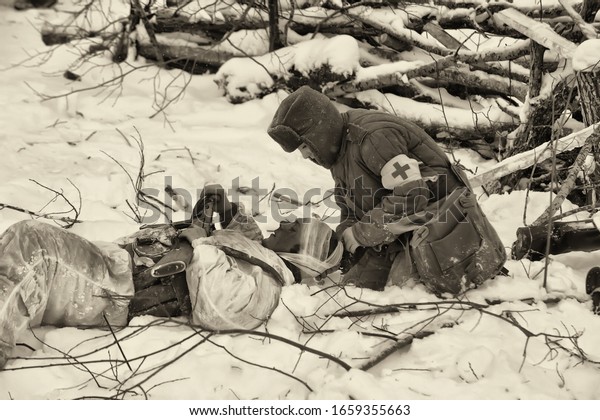 LENINGRAD REGION, RUSSIA - January 22,\
2012: Soviet soldiers of World War II. Military-historical\
reconstruction of the battle, which lifted the siege of\
Leningrad