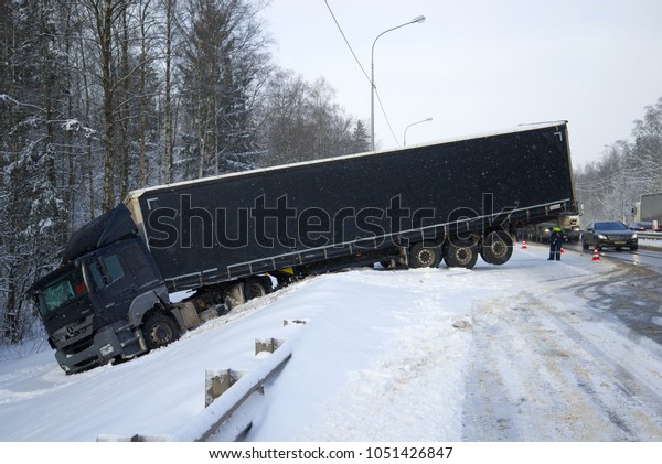 LENINGRAD REGION,
RUSSIA - MARCH 21, 2018: Off highway Mercedes-Benz Axor 1836 with
trailer in March snowfall
