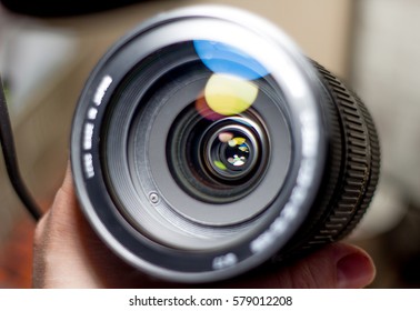lens digital camera, selective focus, close-up, side with reflection, bokeh