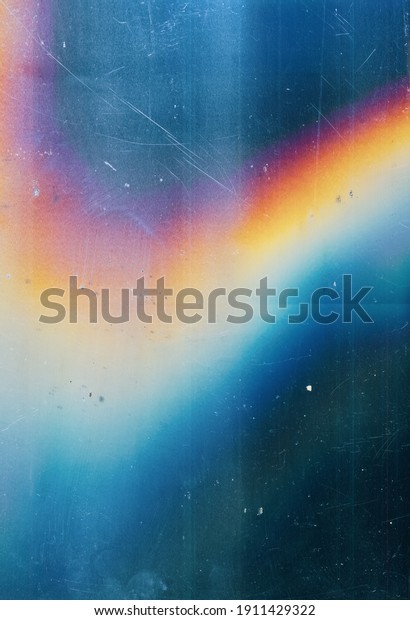 Lens flare background. Dust scratches\
texture. Blue distressed faded stained screen with smeared dirt\
noise blur colorful orange rainbow glow\
defect.