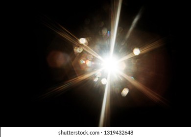 Lens Flare. Light over black background. Easy to add overlay or screen filter over photos. Abstract sun burst with digital lens flare background. Gleams rounded and hexagonal shapes, rainbow halo. - Shutterstock ID 1319432648