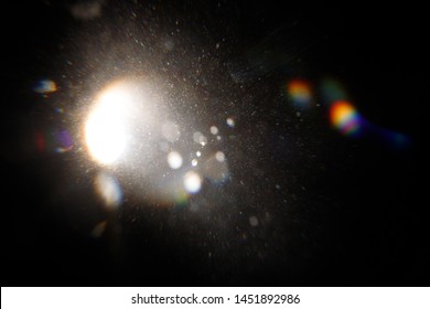 Lens Flare. Light over black background. Easy to add overlay or screen filter over photos. Abstract sun burst with digital lens flare background. Gleams rounded and hexagonal shapes, rainbow halo. - Shutterstock ID 1451892986