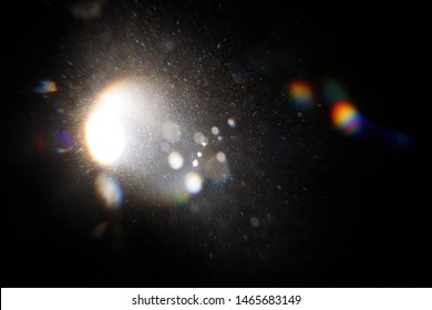 Lens Flare. Light over black background. Easy to add overlay or screen filter over photos. Abstract sun burst with digital lens flare background. Gleams rounded and hexagonal shapes, rainbow halo. - Shutterstock ID 1465683149