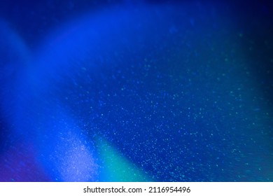 Lens Flare Overlay. Blur Grain Texture. Shimmering Glow Filter. Defocused Neon Blue Iridescent Color Light Abstract Design On Dark Background.