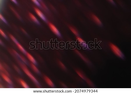 Lens flare overlay. Bokeh light. Flash leak. Blur optical rays. Defocused neon red purple sparks glow on dark night abstract background.