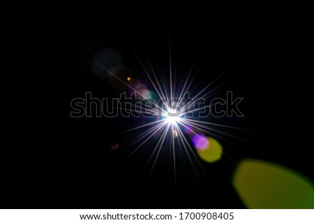Lense flare sunlight ray. Sun shine flash effect or star spot glow light on black background. Gleams rounded and hexagonal shapes, rainbow halo.