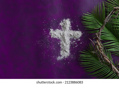 Lent border of cross of ashes, palm leaves and crown of thorns on a dark purple background