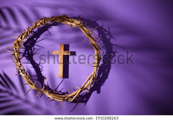 Lent season, Holy week and Good\
friday concept. Crown of torns and cross on purple\
background