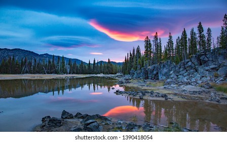 A lenticular cloud reflected in sparks lake, Oregon cascade mountains near Bend, Oregon
