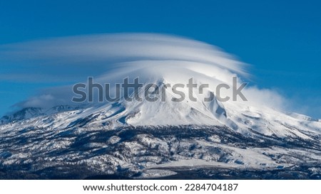 Lenticular clouds over Mount Shasta and Shastina's northwest facing view. Cascade Mountain Range. Siskiyou County, California. Shasta–Trinity National Forest.