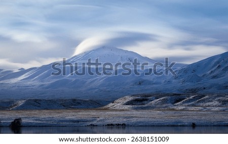 Lenticular clouds over mountain top at Lake Clearwater. Ashburton Lakes region. Canterbury. New Zealand.