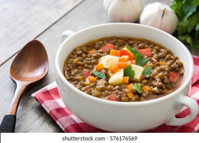 Lentil soup in a bowl on wooden background
