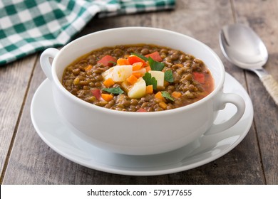 Lentil soup in a bowl on wooden background
