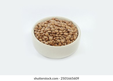 Lentils in a bowl on a white background.