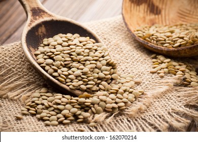 Lentils Wooden Spoon On Wooden Background. Healthy Food.