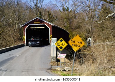 Leola, PA / USA – February 3, 2020: Pinetown Bridge is a red, 133 feet long covered bridge that spans the Conestoga River in Lancaster County.