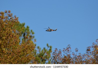 Leonardtown, Maryland/USA - November 5, 2016: Maryland State Police Helicopter In Flight Over Autumn Leaves