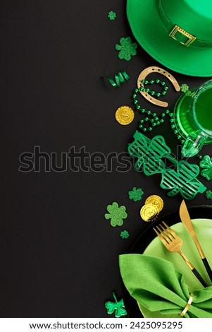Leprechaun's delight: a spirited table for St. Paddy's merriment. Top view vertical shot of plates, cutlery, green party glasses, confetti, hat, green beer on black background with greeting zone