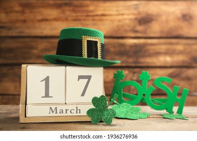 Leprechaun's hat, block calendar and St. Patrick's day decor on wooden table - Powered by Shutterstock