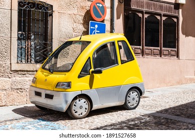 Lerma, Spain - April 16, 2019: Small Yellow Electric Car Parked On Street.