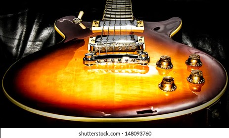 Les Paul shape guitar on back leather background