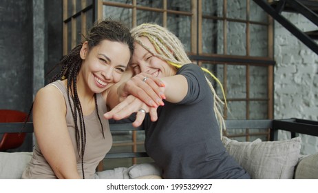 Lesbian Couple Celebrating Their Engagement Showing The Rings