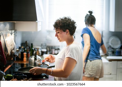 Lesbian Couple Cooking In The Kitchen Together