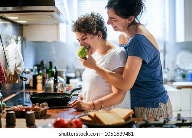 Lesbian Couple Cooking In The Kitchen Together