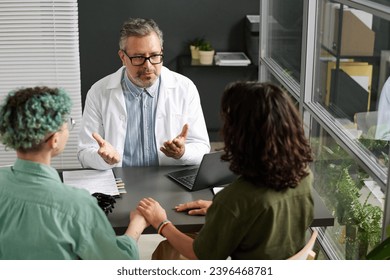 Lesbian couple discussing health with doctor - Powered by Shutterstock