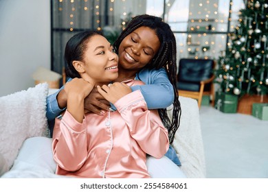 A lesbian couple embraces joyfully in a festive, beautifully decorated area with lights. - Powered by Shutterstock