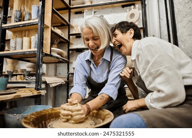 A lesbian couple enjoys pottery class, laughing as one shapes clay on a wheel. - Powered by Shutterstock