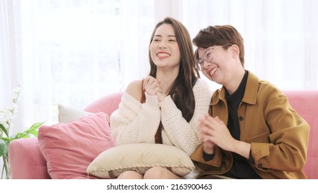 Lesbian Couple Is Excitedly Watching Live Football Match On Sofa.