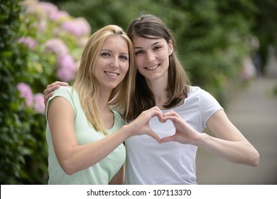 Lesbian Couple Forming Heart Shape With Hands