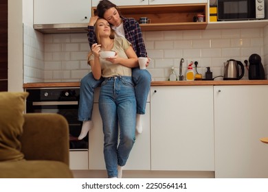 Lesbian couple in love. Girlfriend hugged her girlfriend in kitchen. - Powered by Shutterstock