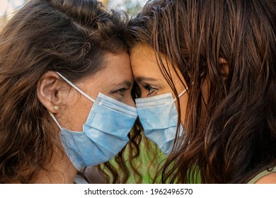 Lesbian Couple With Mask In The Park