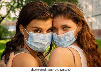 Lesbian Couple With Mask In The Park