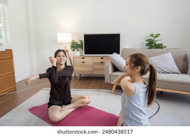 Lesbian Couple Practicing Yoga Together at Home, Smiling and Stretching on Yoga Mats in a Cozy Living Room Setting - Powered by Shutterstock