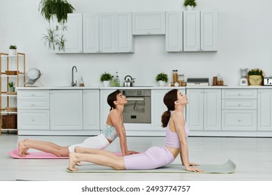 A lesbian couple practicing yoga together in a modern kitchen. - Powered by Shutterstock