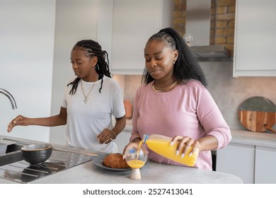 Lesbian couple preparing breakfast in kitchen - Powered by Shutterstock