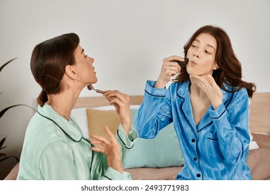 A lesbian couple relaxes in pajamas, enjoying a quiet morning routine together. - Powered by Shutterstock