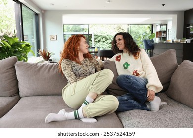 Lesbian couple relaxing on sofa at home - Powered by Shutterstock