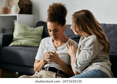 A lesbian couple shares a tender moment in their living room, offering support and solace to one another. - Powered by Shutterstock