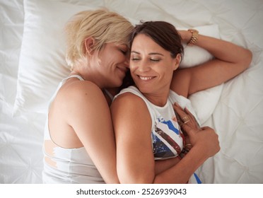 Lesbian, couple and smile with hug on bed for comfort, marriage commitment and morning romance. Above, lgbtq women and relax with affection, bonding together and loyalty for relationship at house - Powered by Shutterstock