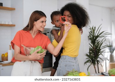 Lesbian couple with their little baby in kitchen - Powered by Shutterstock