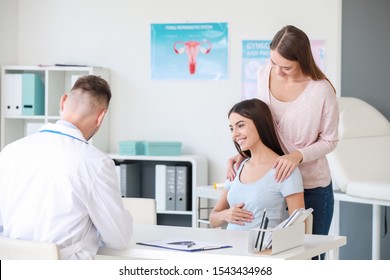 Lesbian Couple Visiting Male Gynecologist In Clinic