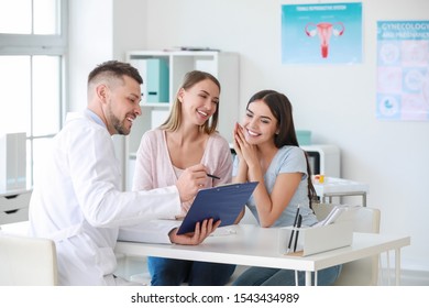 Lesbian Couple Visiting Male Gynecologist In Clinic