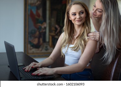 Lesbian domestic freelancer couple at home, calm touch on shoulder - Powered by Shutterstock