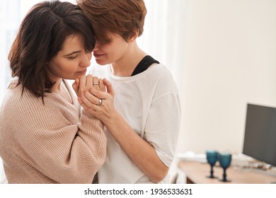 Lesbian lady standing and bonding to her girlfriend while dancing - Shutterstock ID 1936533631